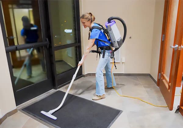 Commercial cleaner maintaining a retail storefront entrance in Austin